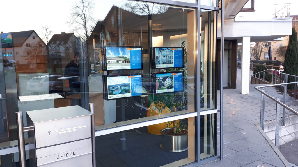 Four bright listing screens in a window