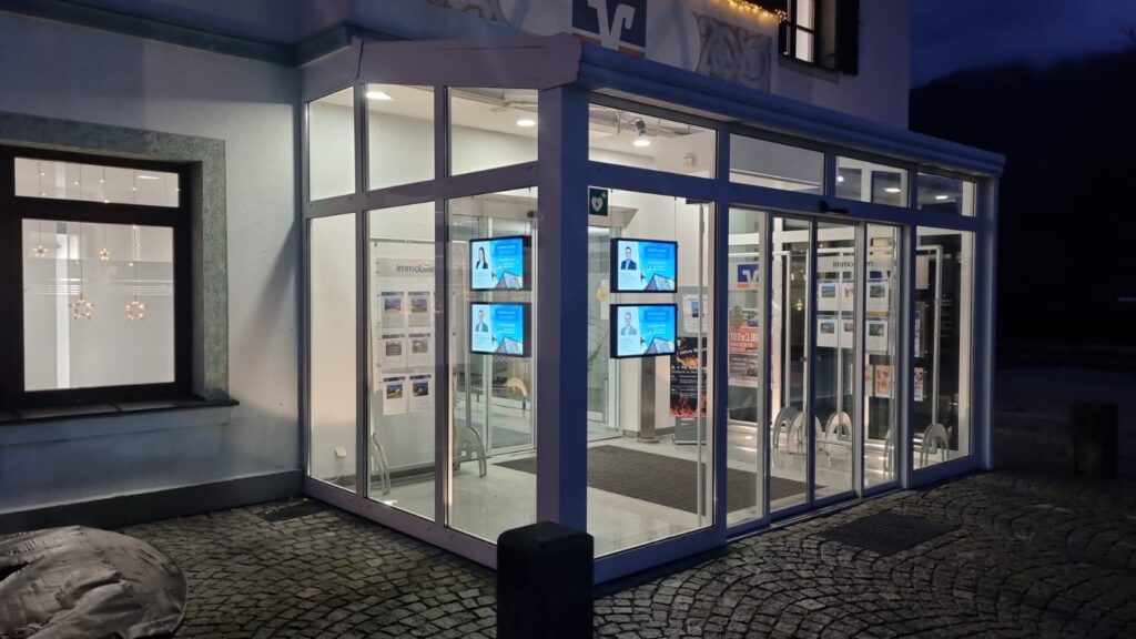 Bright storefront display visible at night